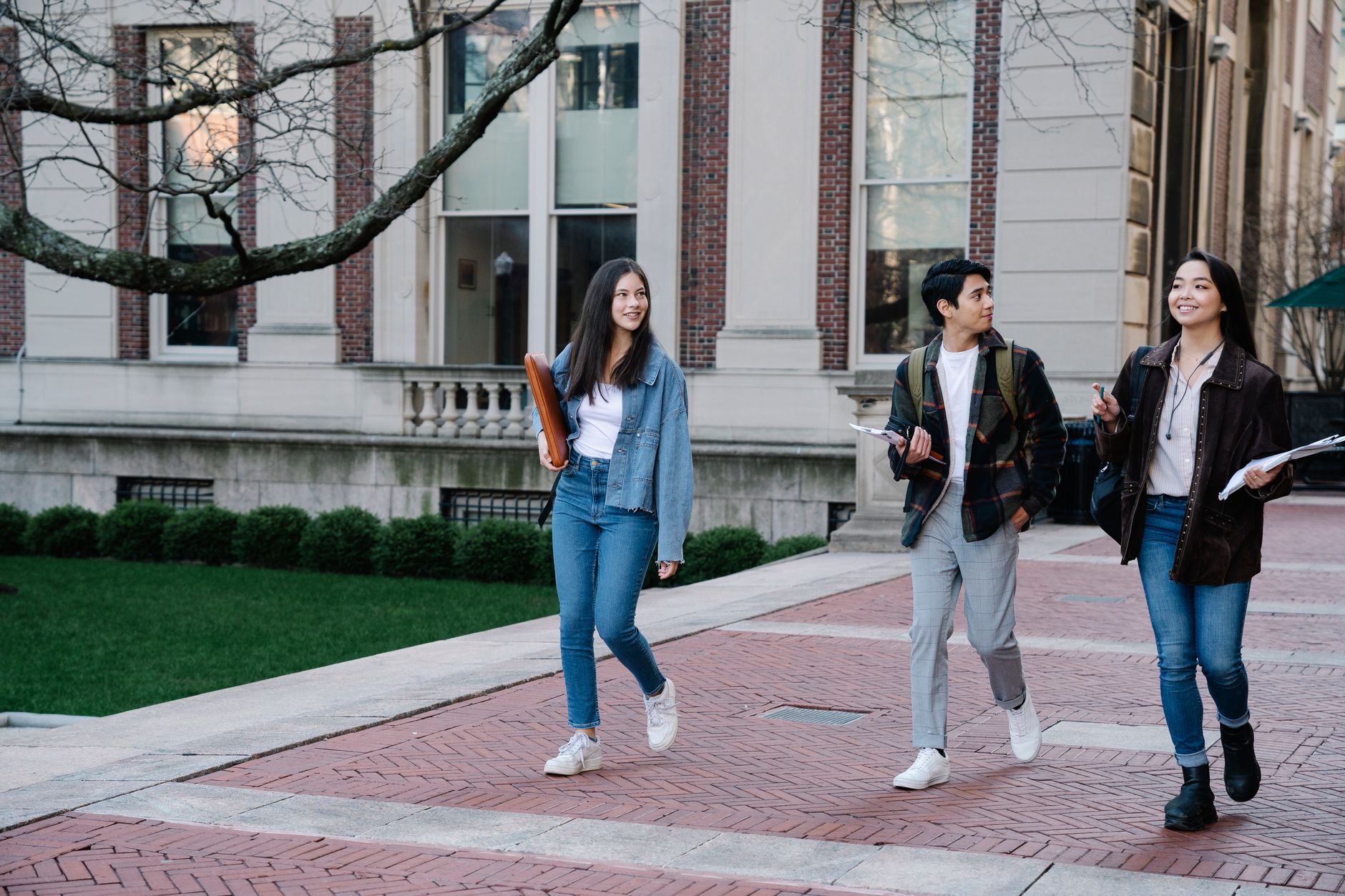 Students walking through a Sydney university campus between classes, showing the on-campus study environment for the applied degrees